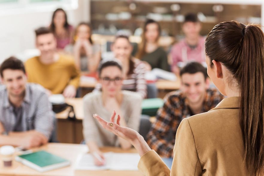 Rear view of teacher giving a lecture.
